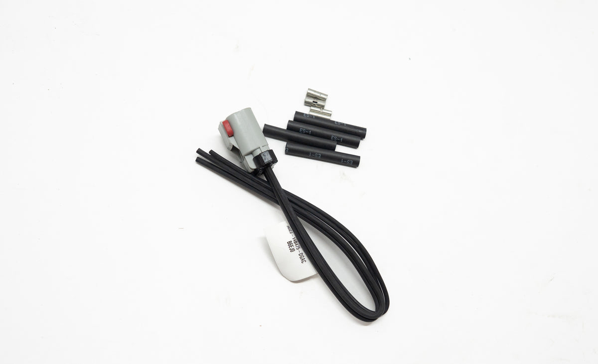 Set of electronic connectors and black wires on a white background