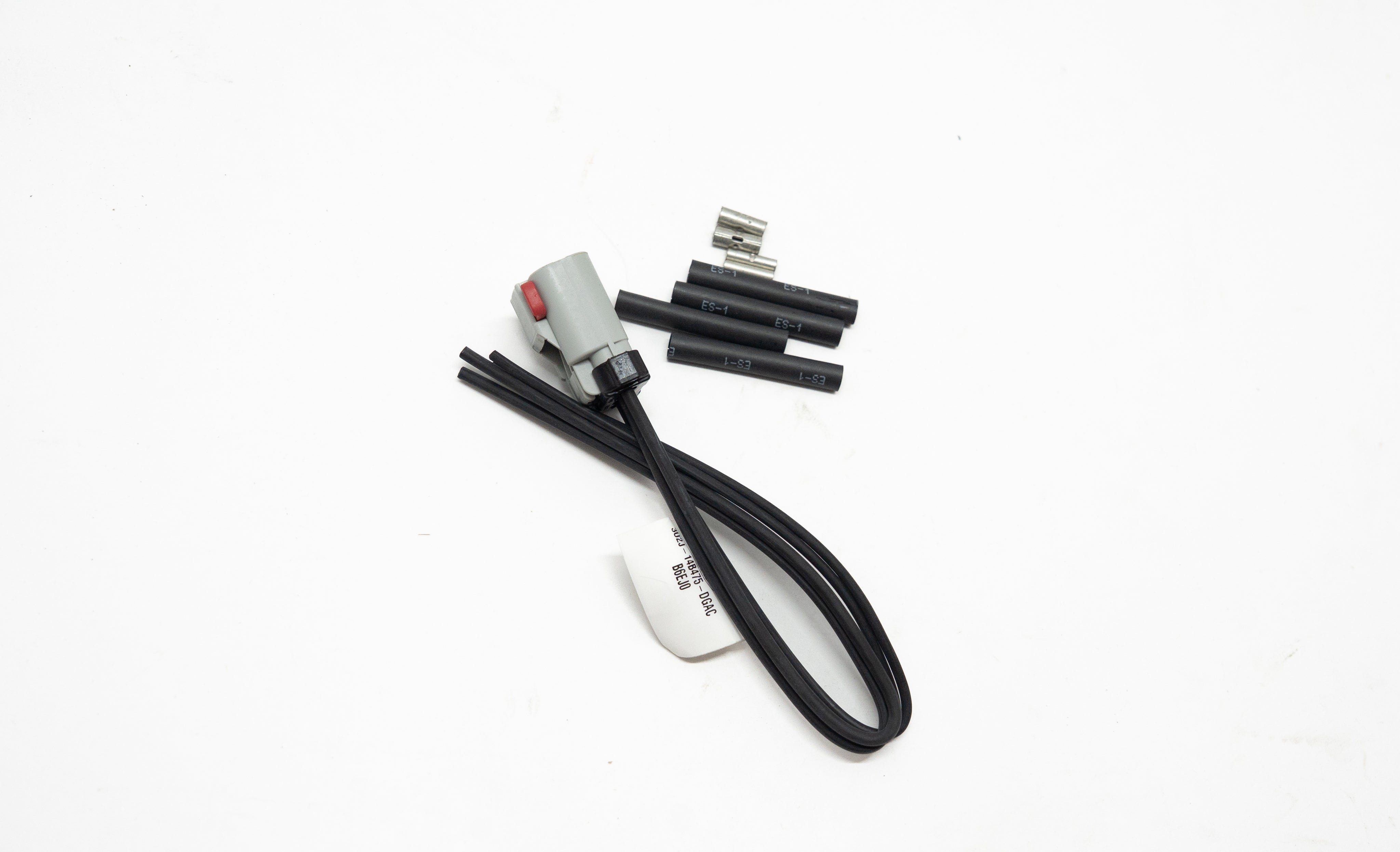 Set of electronic connectors and black wires on a white background