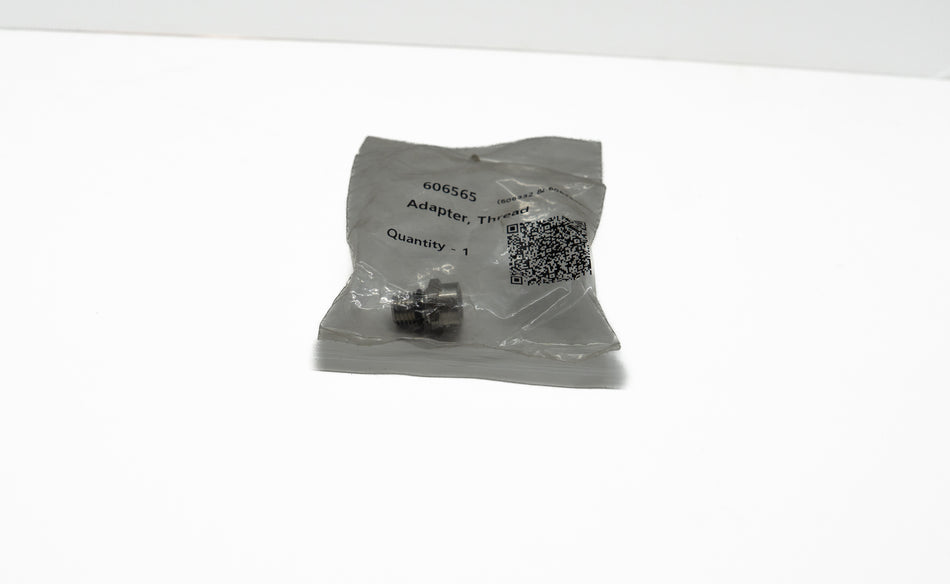 Small metal component in a clear plastic bag with labels on a white background