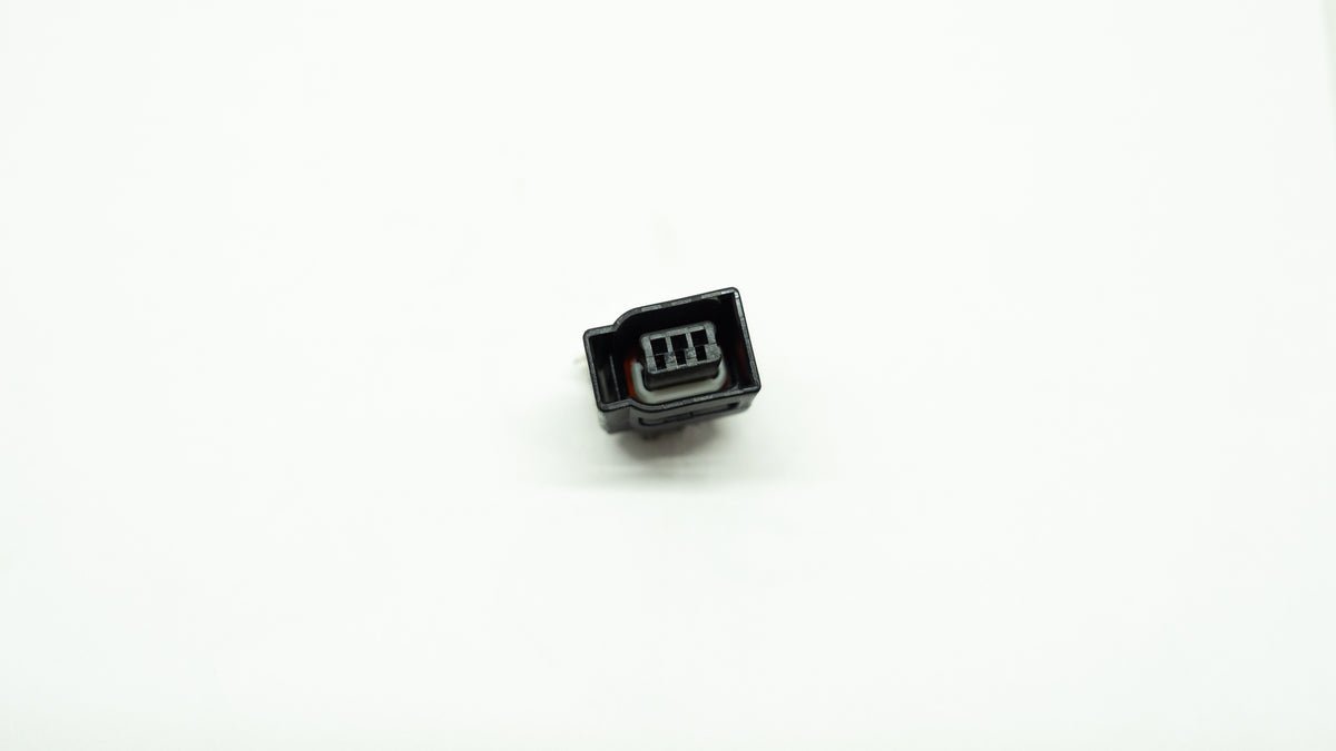Small black electronic connector on a white background