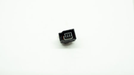 Small black electronic connector on a white background
