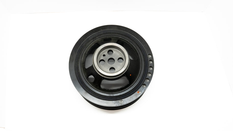 Black automotive crankshaft pulley on a white background