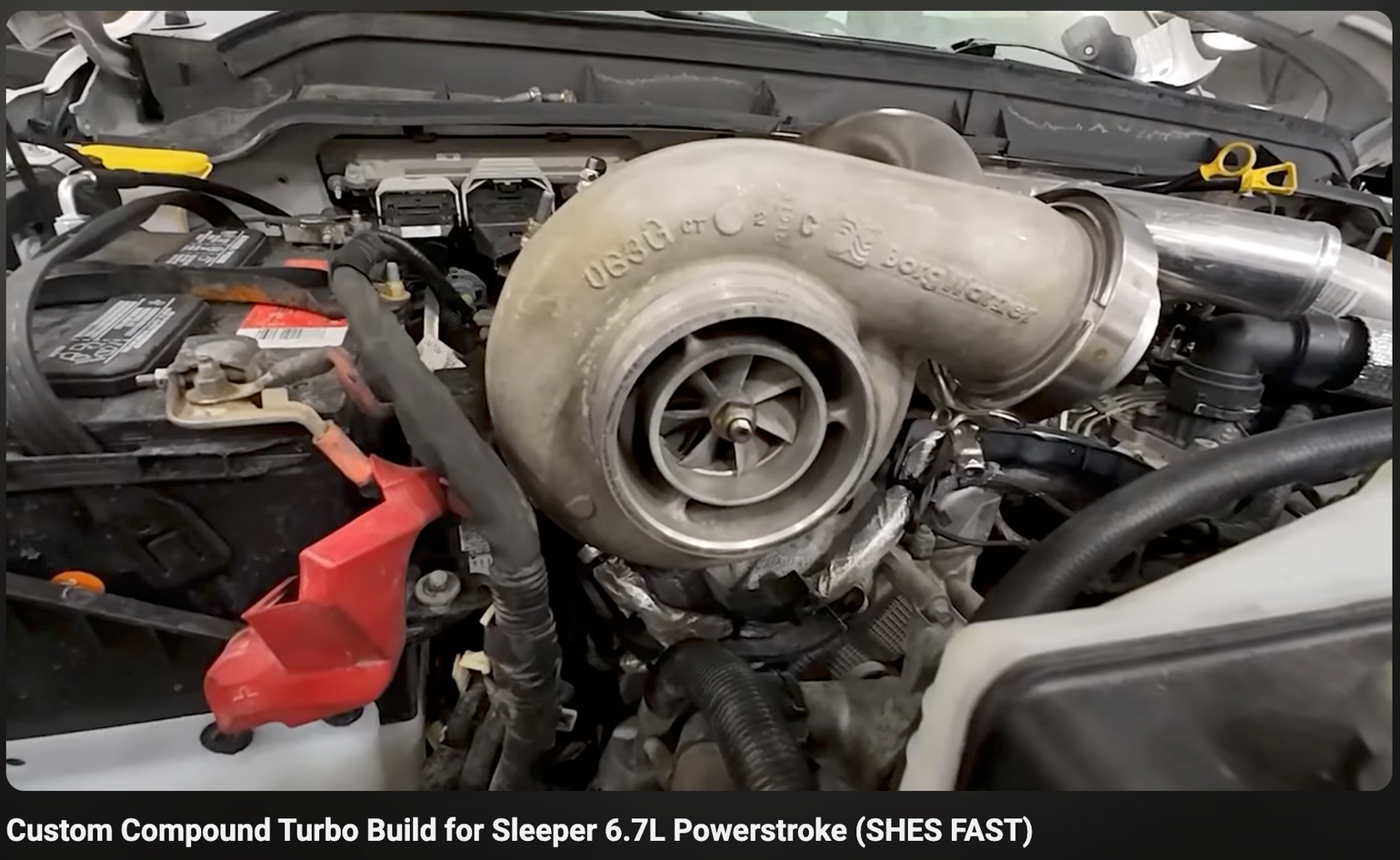 Turbocharger in a 6.7L Powerstroke engine bay with visible branding.