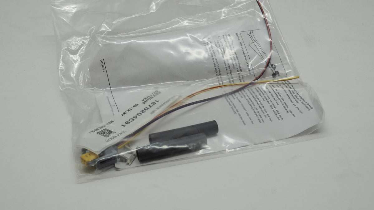 Electronic wiring kit with components in a clear plastic bag on a white background
