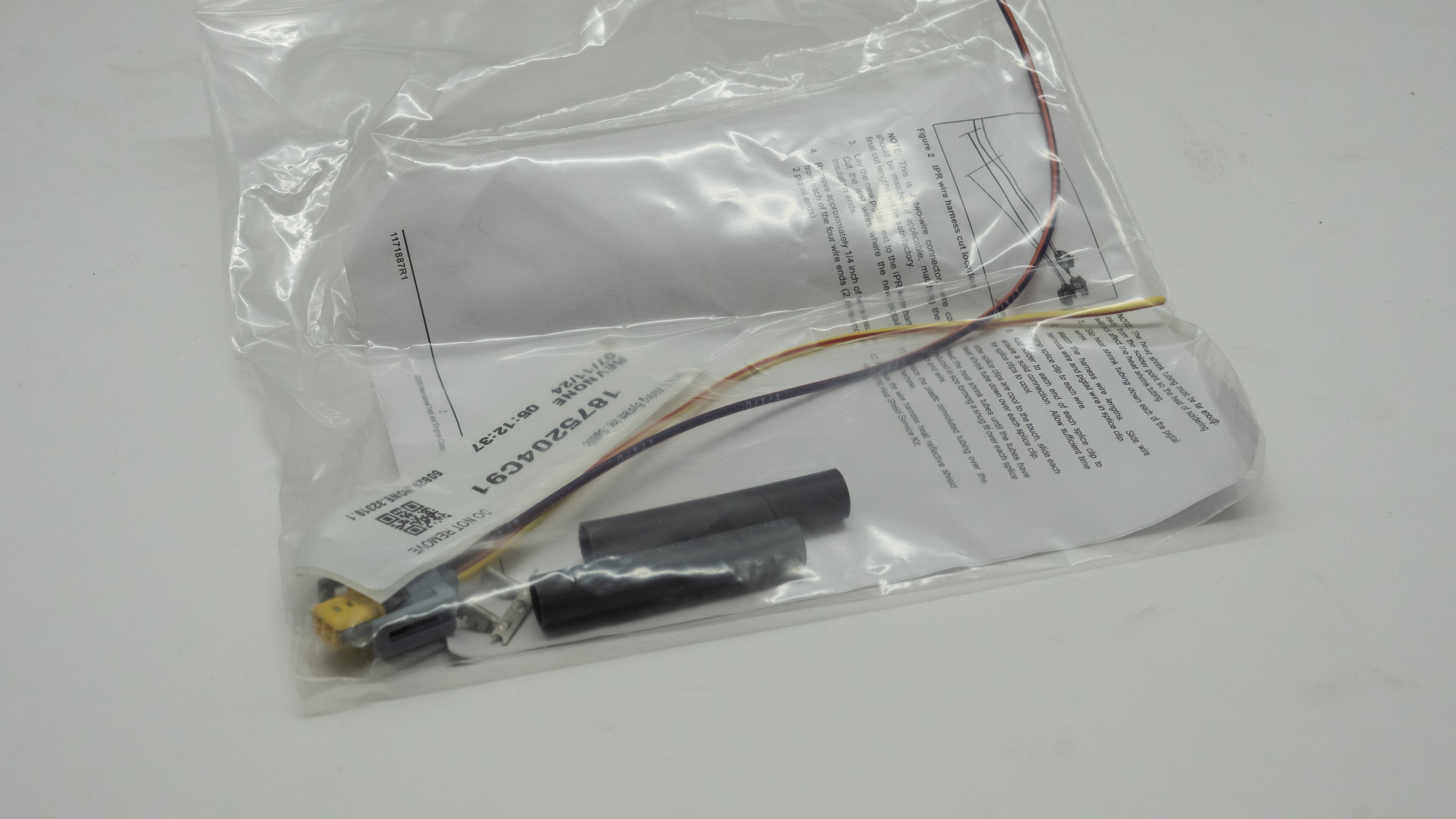 Electronic wiring kit with components in a clear plastic bag on a white background