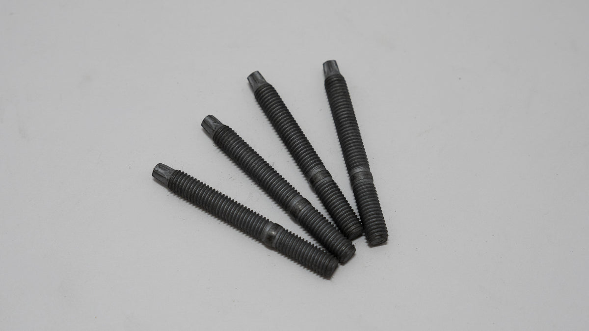 Five black threaded exhaust manifold studs on a gray background
