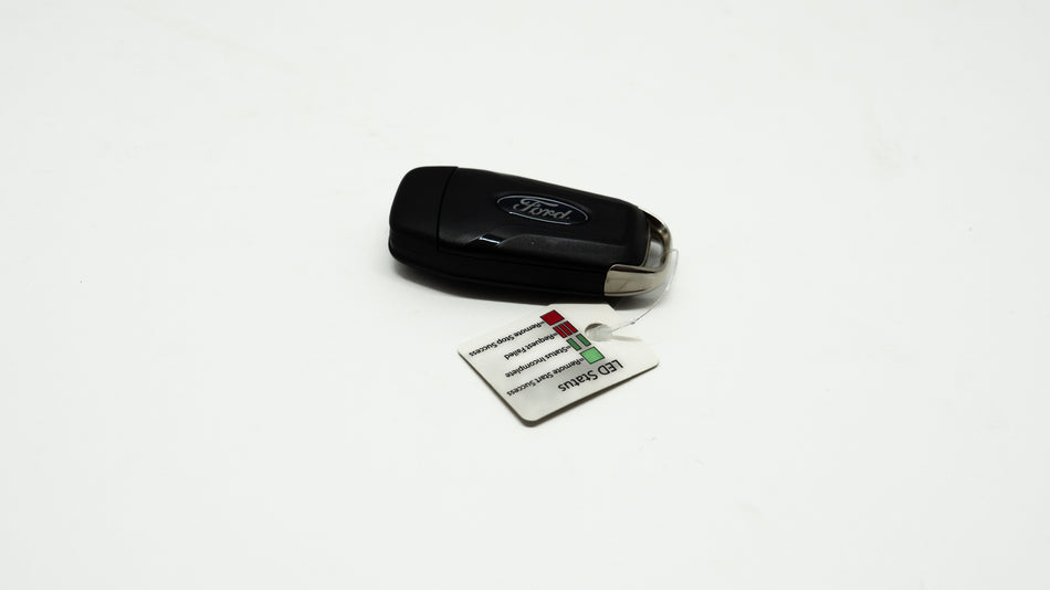 Black car key fob with a card on a white background