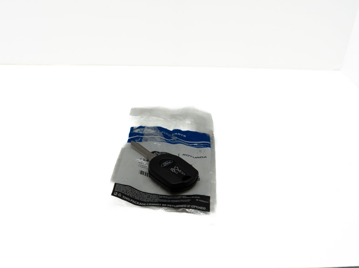 Black remote control automotive key fob in a clear plastic bag on a white background