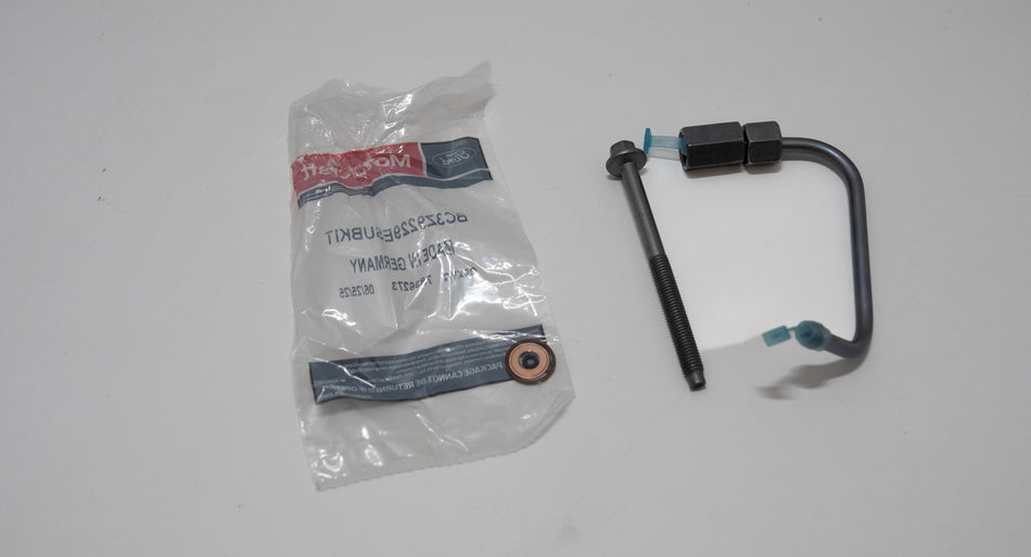 Automotive fuel injector o-ring kit with bolt and tubing next to packaging on a white background