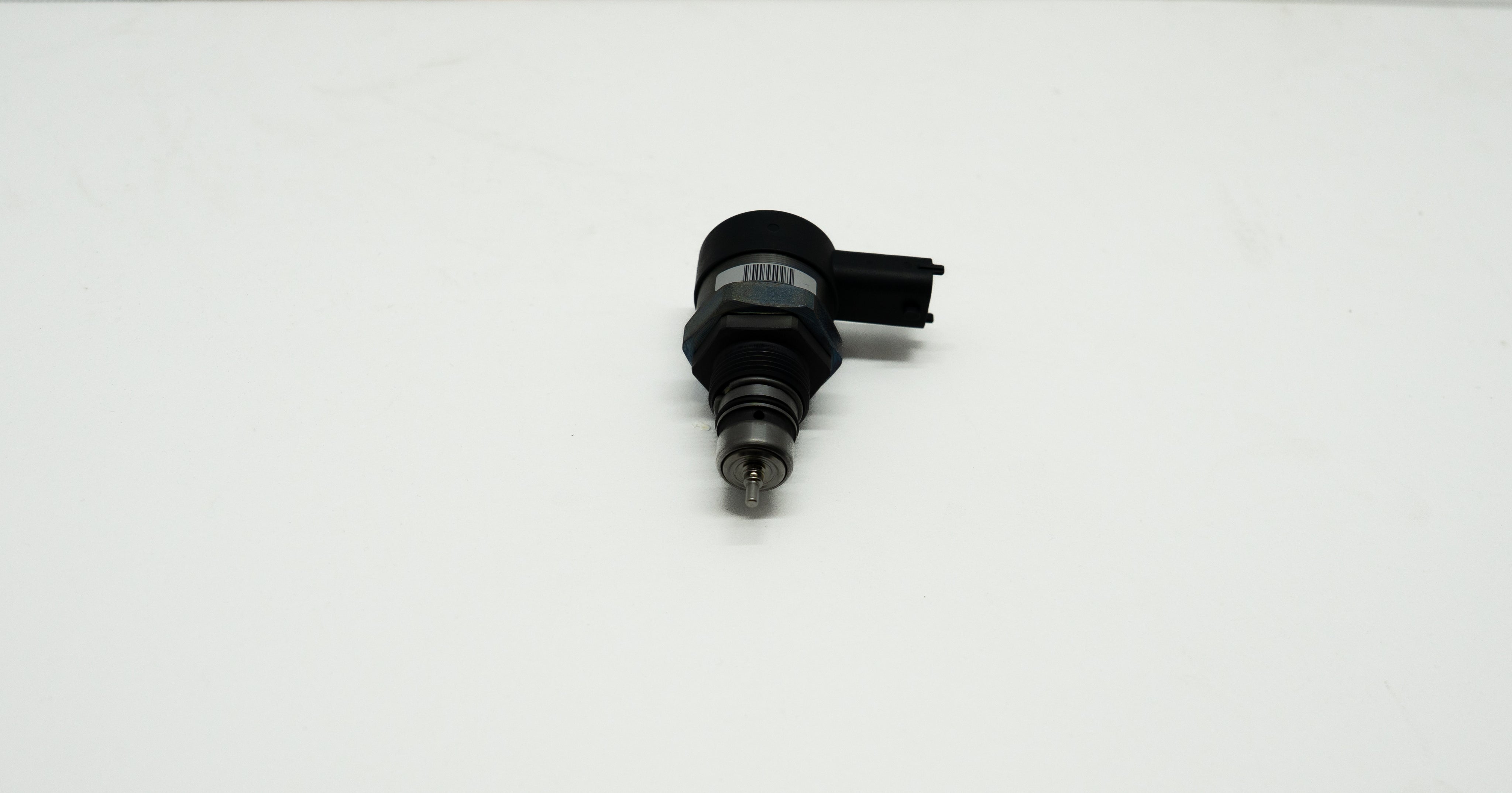 Black mechanical component on a white background