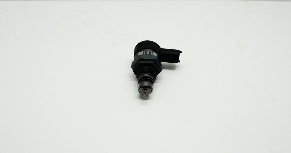 Black mechanical component on a white background