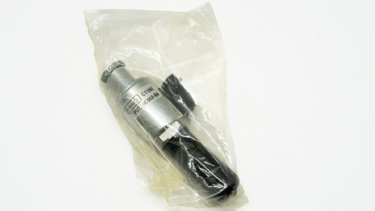 Metallic automotive cylindrical object in a clear plastic bag on a white background