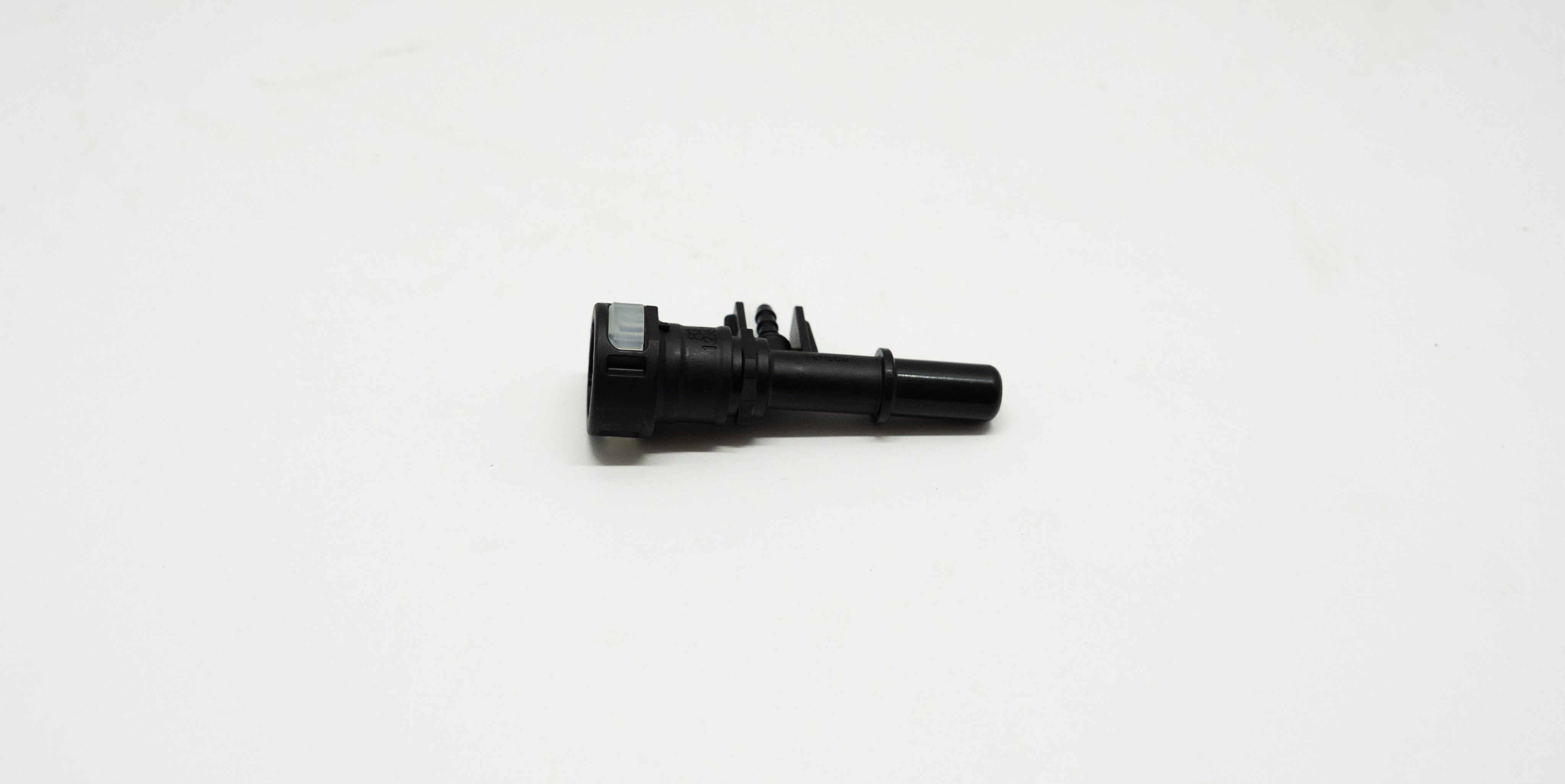 Black plastic mechanical component on a white background