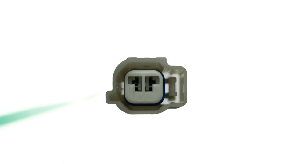 Automotive two prong wiring connector on a white background.
