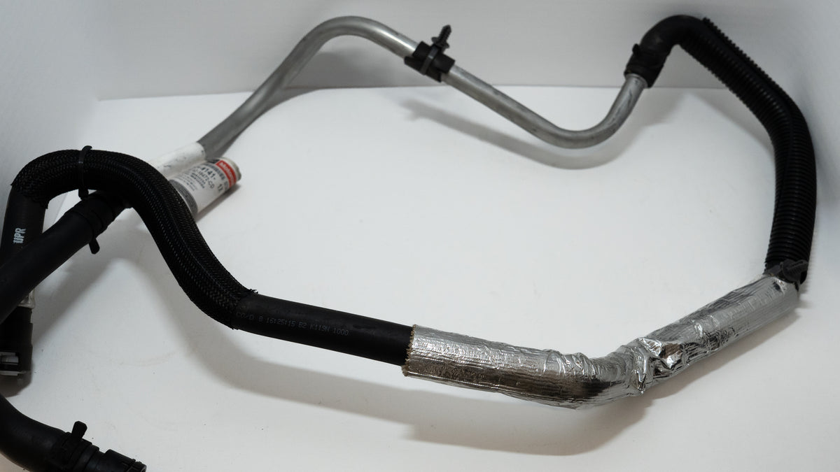 Set of automotive HVAC heater hoses on a white background
