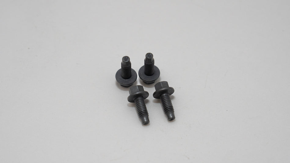 Four black screws on a white background