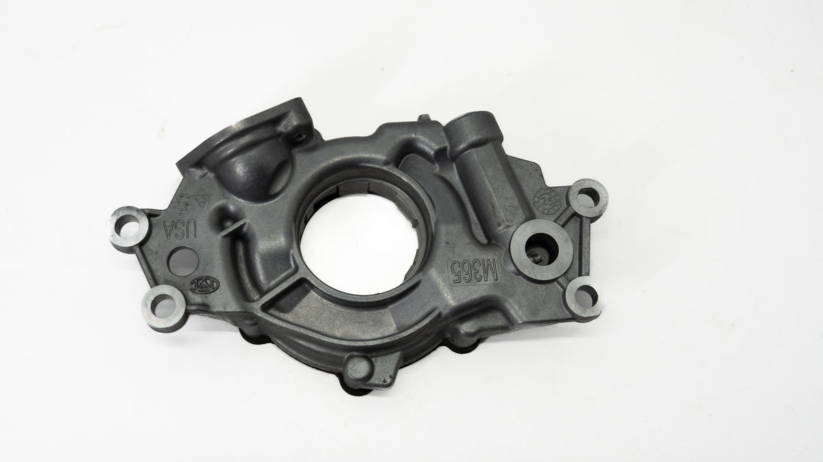 Metal automotive oil pump on a white background