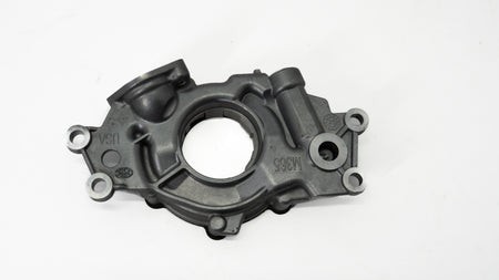 Metal automotive oil pump on a white background