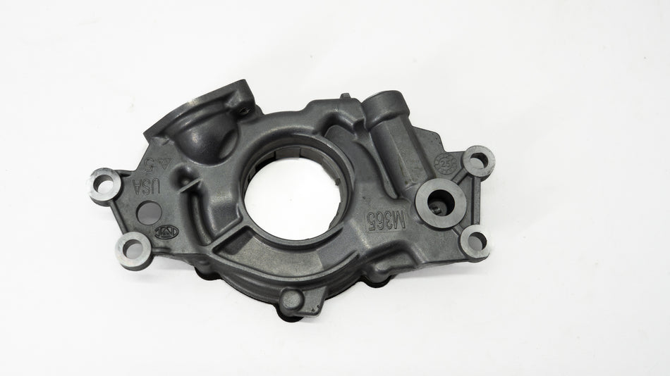 Metal automotive oil pump on a white background