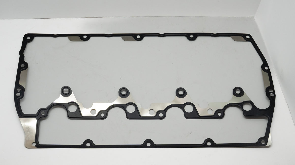 Black rubber head gasket on a white background