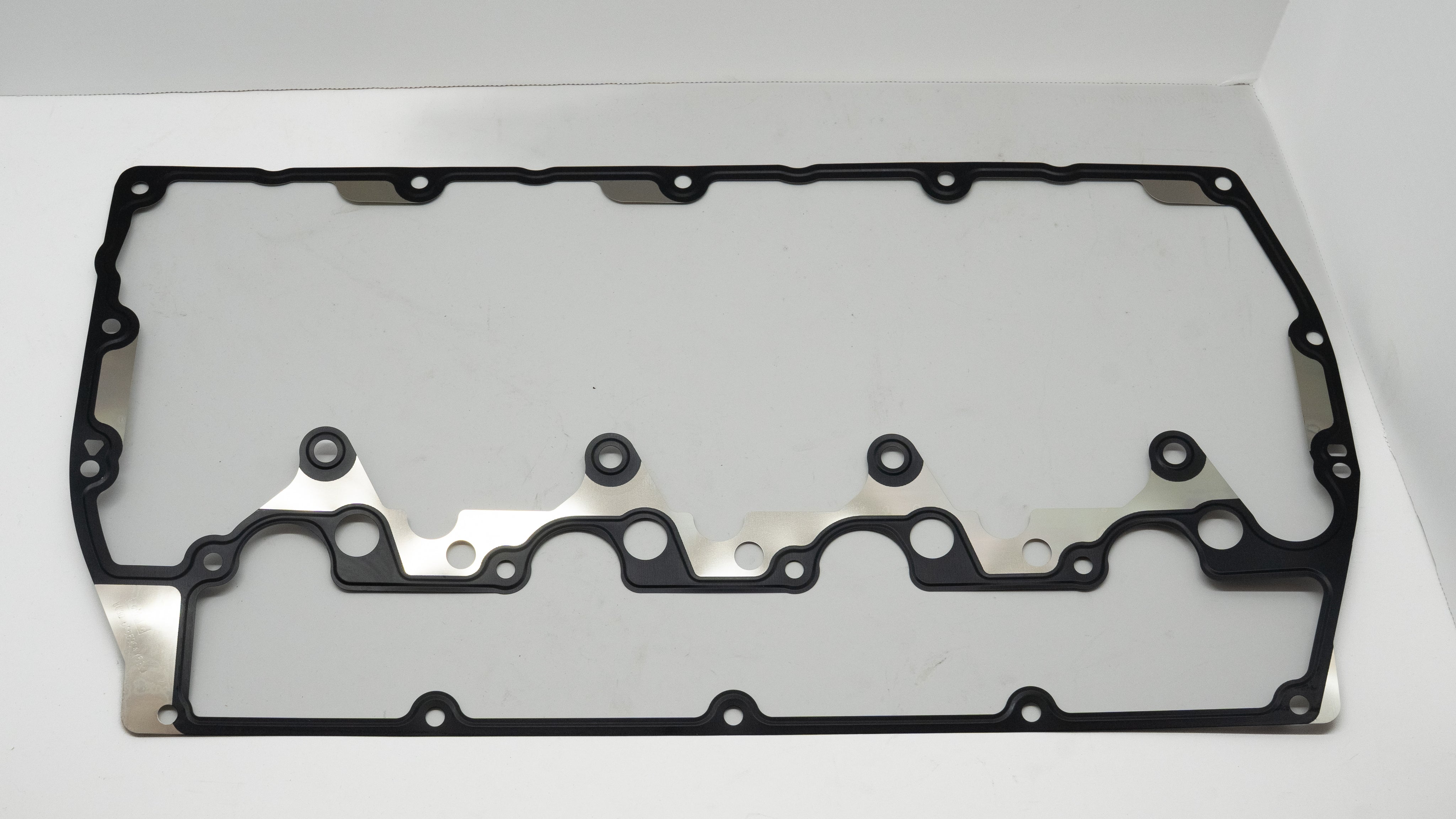 Black rubber head gasket on a white background