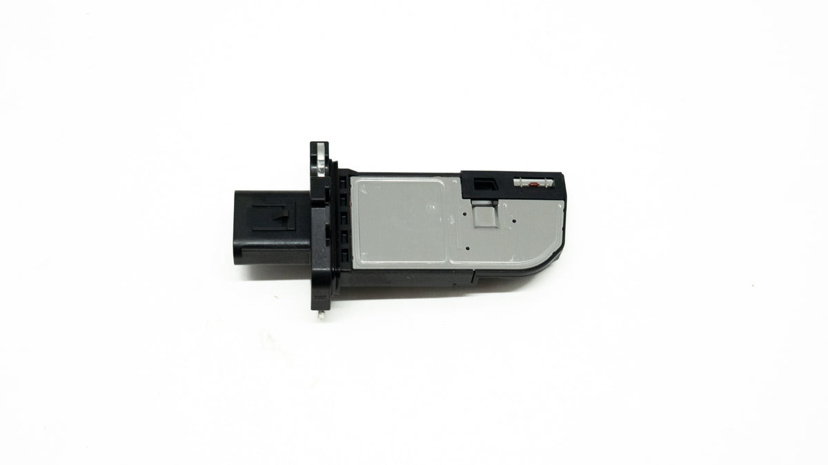 Black and silver automotive sensor on a white background