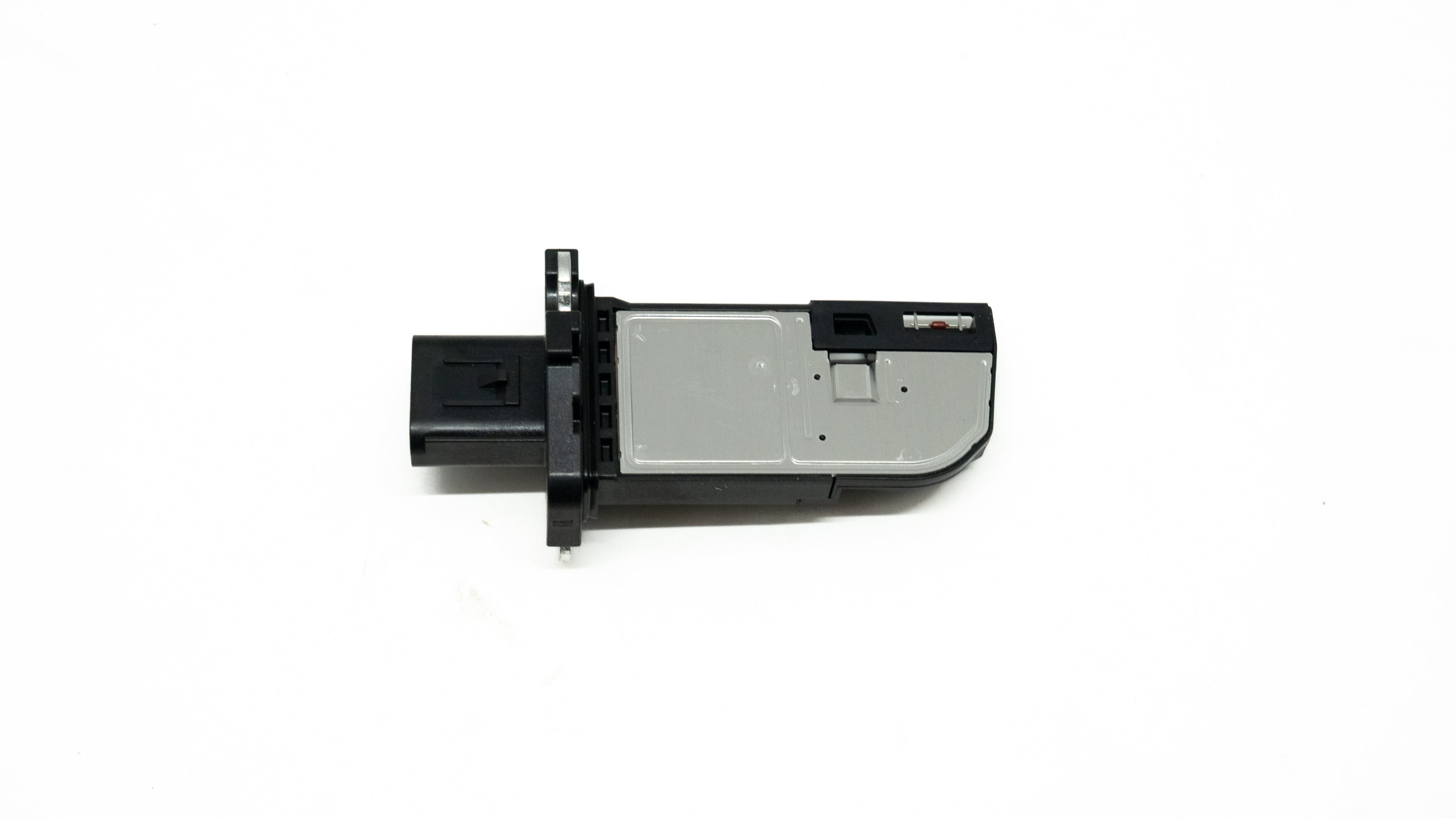 Black and silver automotive sensor on a white background