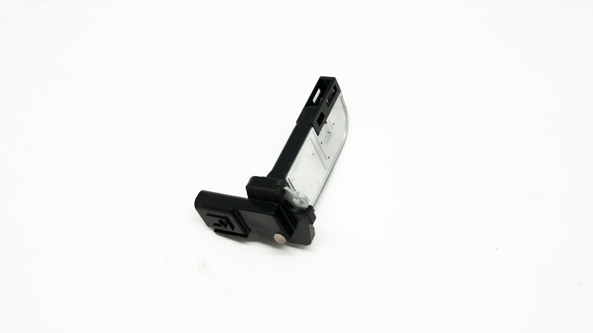 Black and silver rectangular automotive sensor on a white background