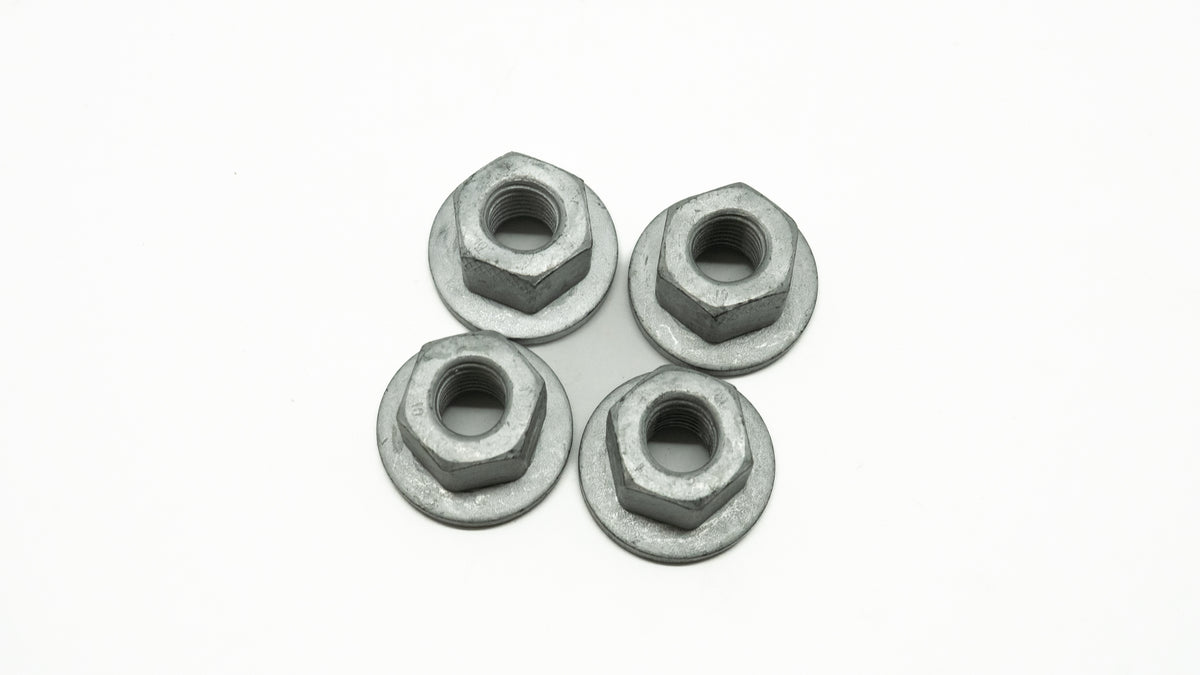 Four metal nuts on a white background