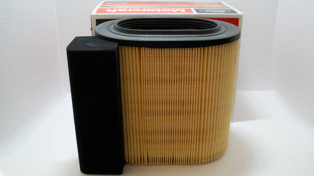Engine air intake filter and assembly with packaging on a white background.