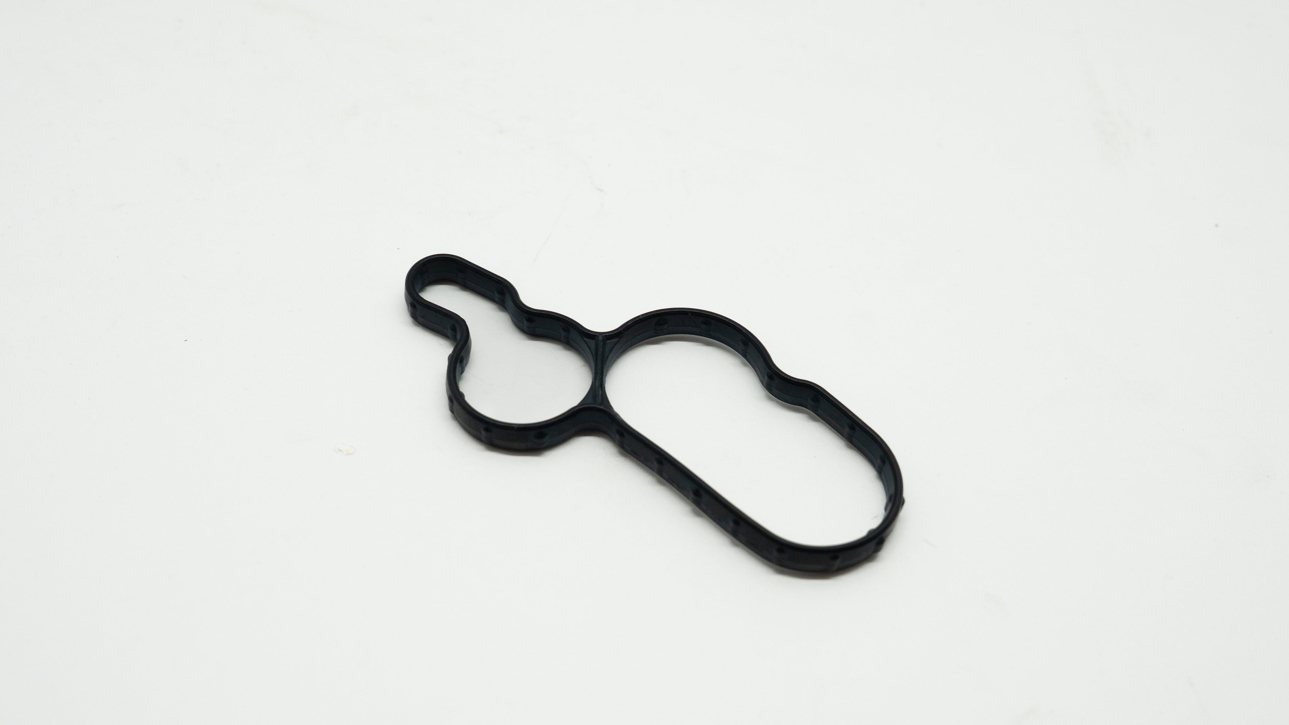 Black rubber gasket on a white background