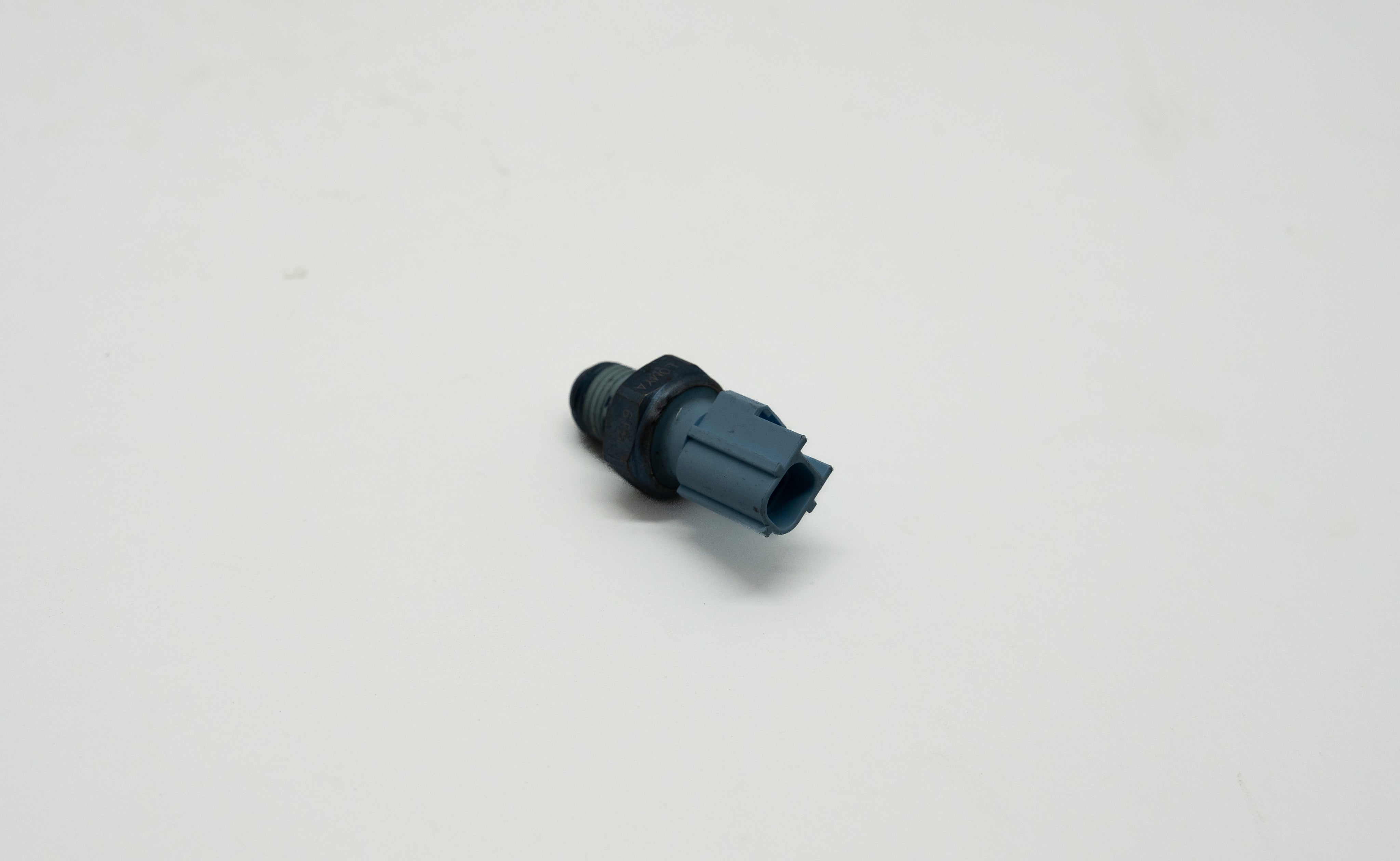 Blue and grey tubular mechanical component on a white background