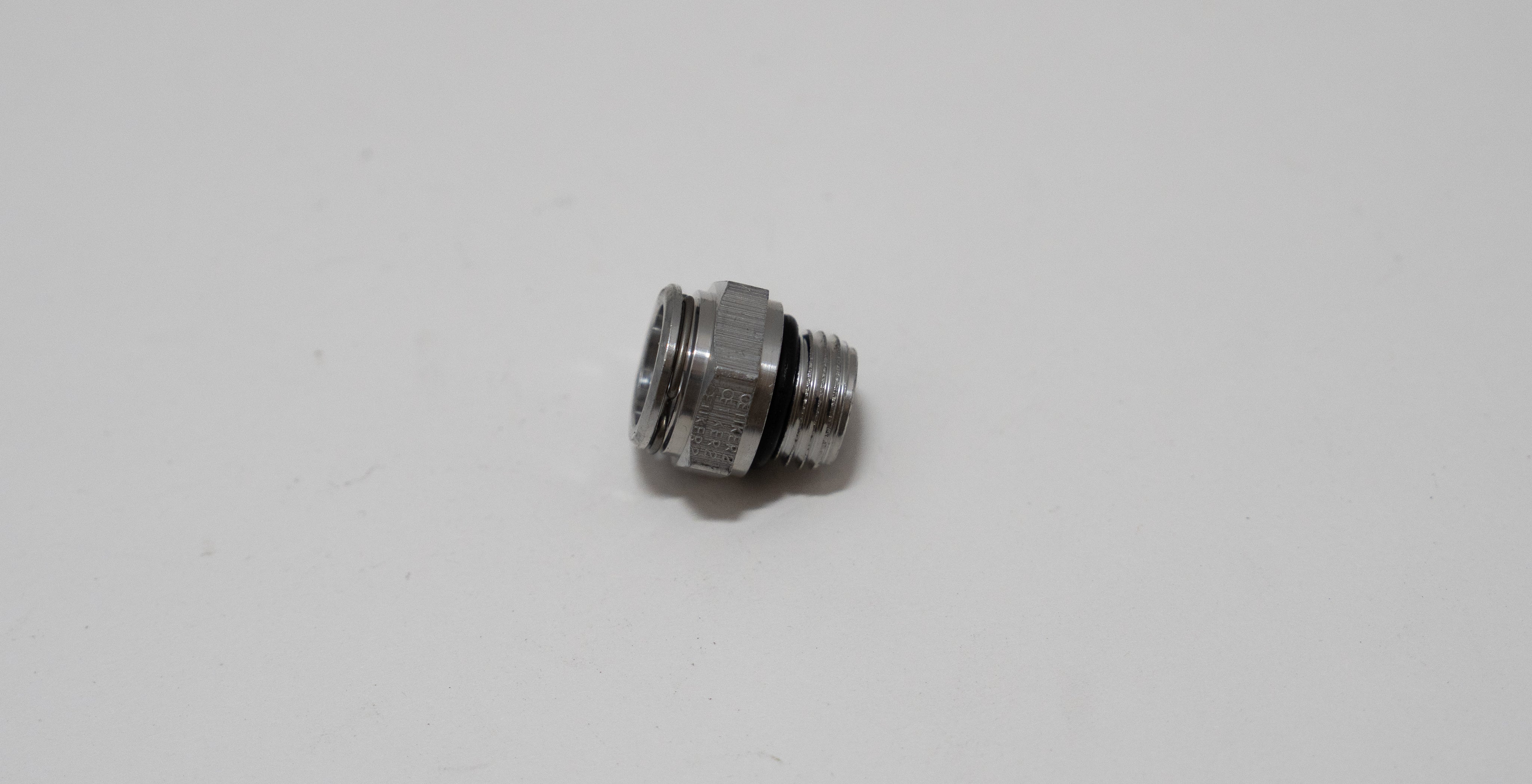 Automotive metal fitting on a white background