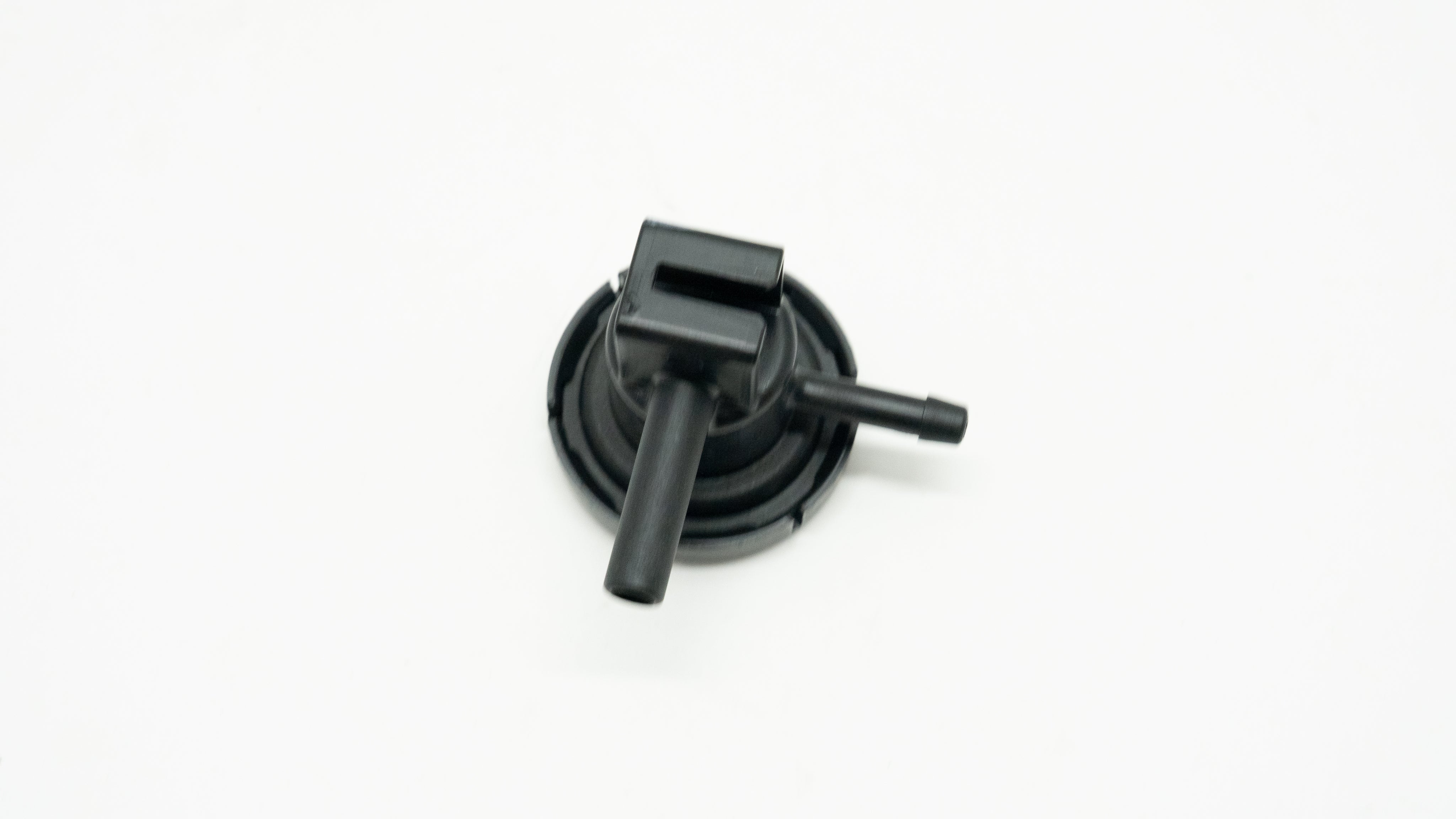 Black mechanical component on a white background