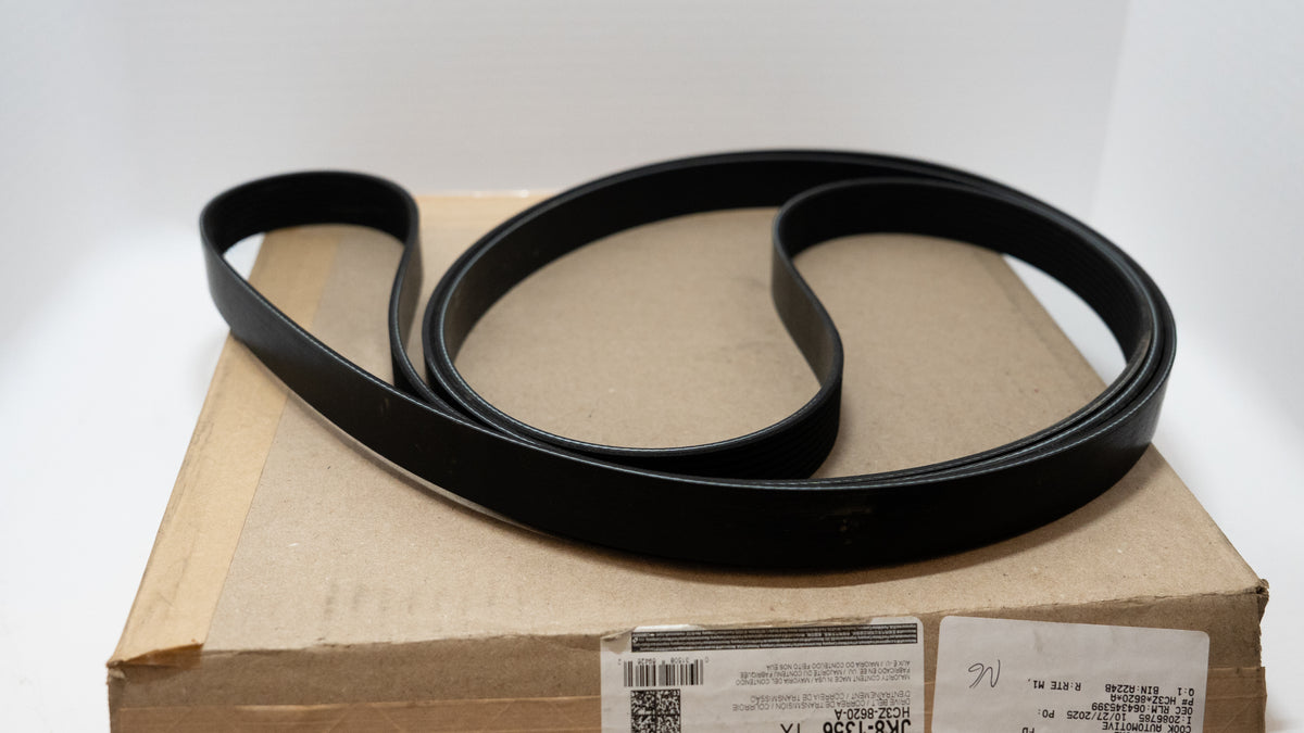 Black automotive belt with shipping box on a white background. 