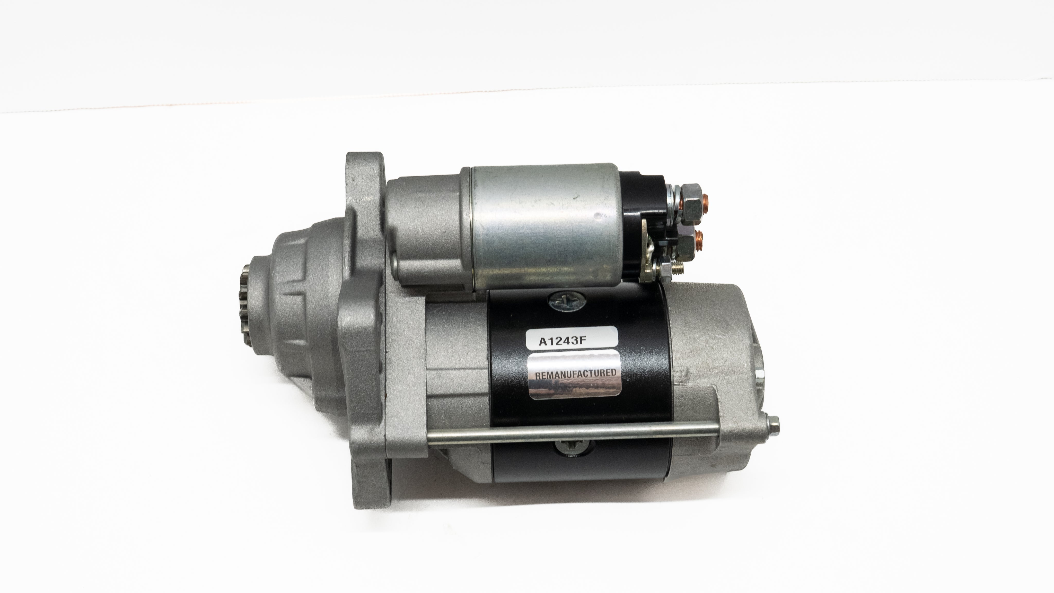 Automotive starter motor on a white background