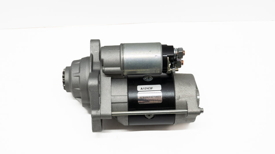 Automotive starter motor on a white background