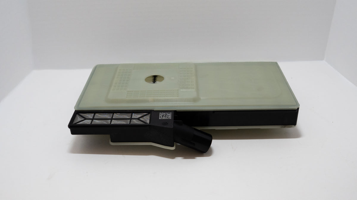 Gray, square transmission oil filter with a black component on a white background