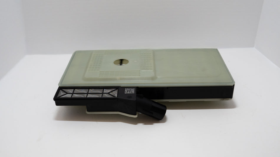 Gray, square transmission oil filter with a black component on a white background