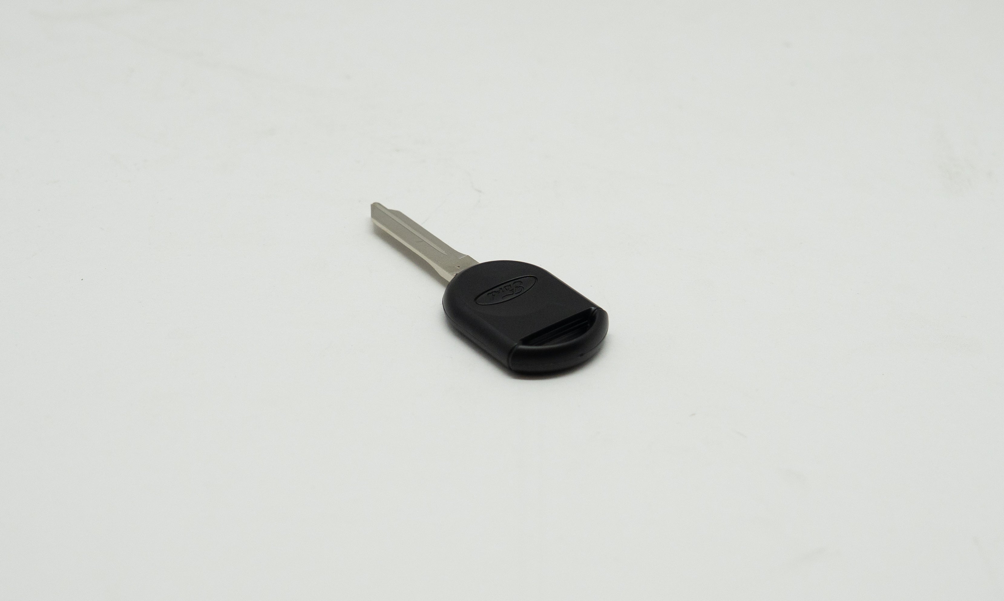 Black and metal car key on white background. 