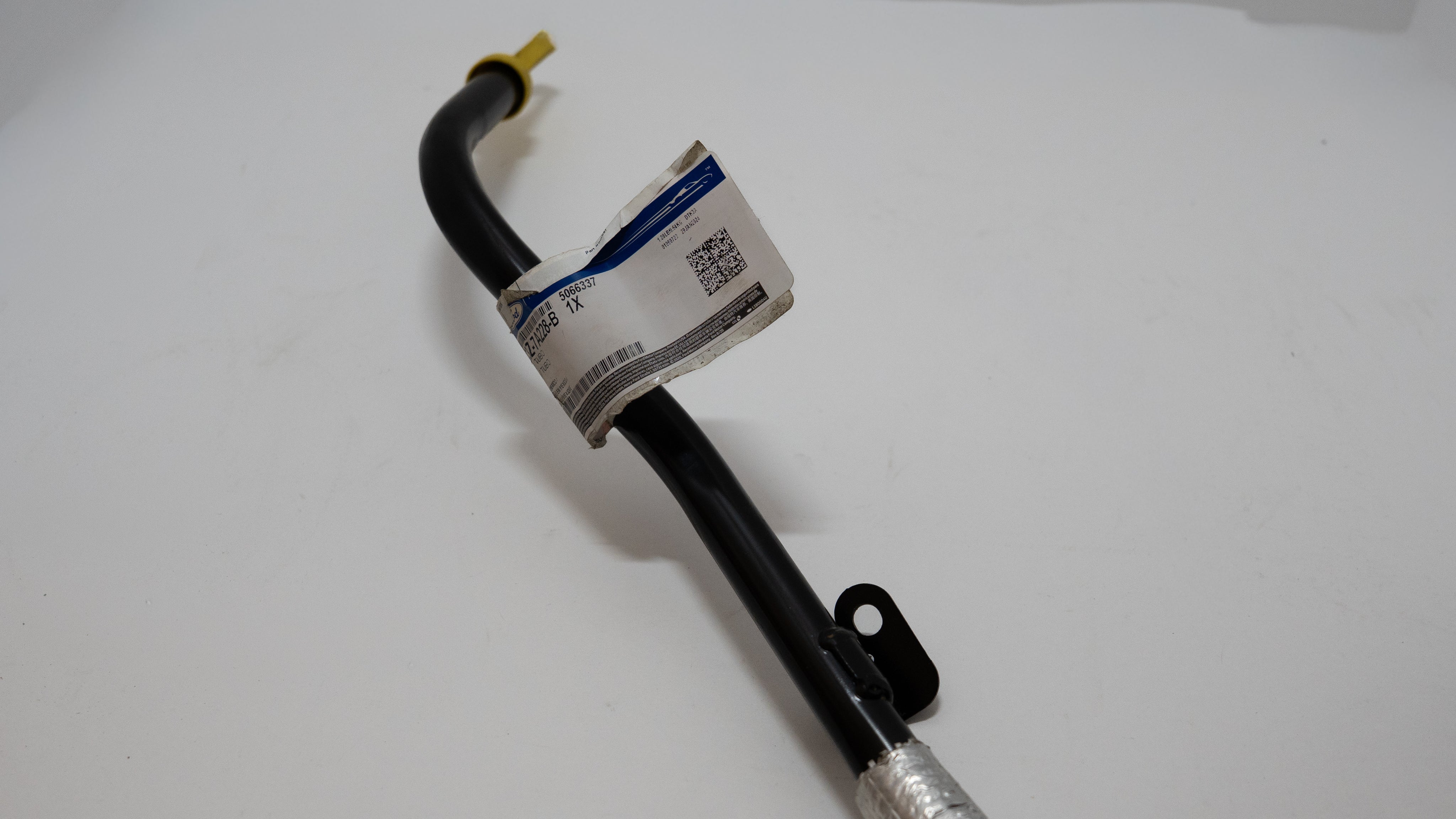 Black metal hose with a label on a white background