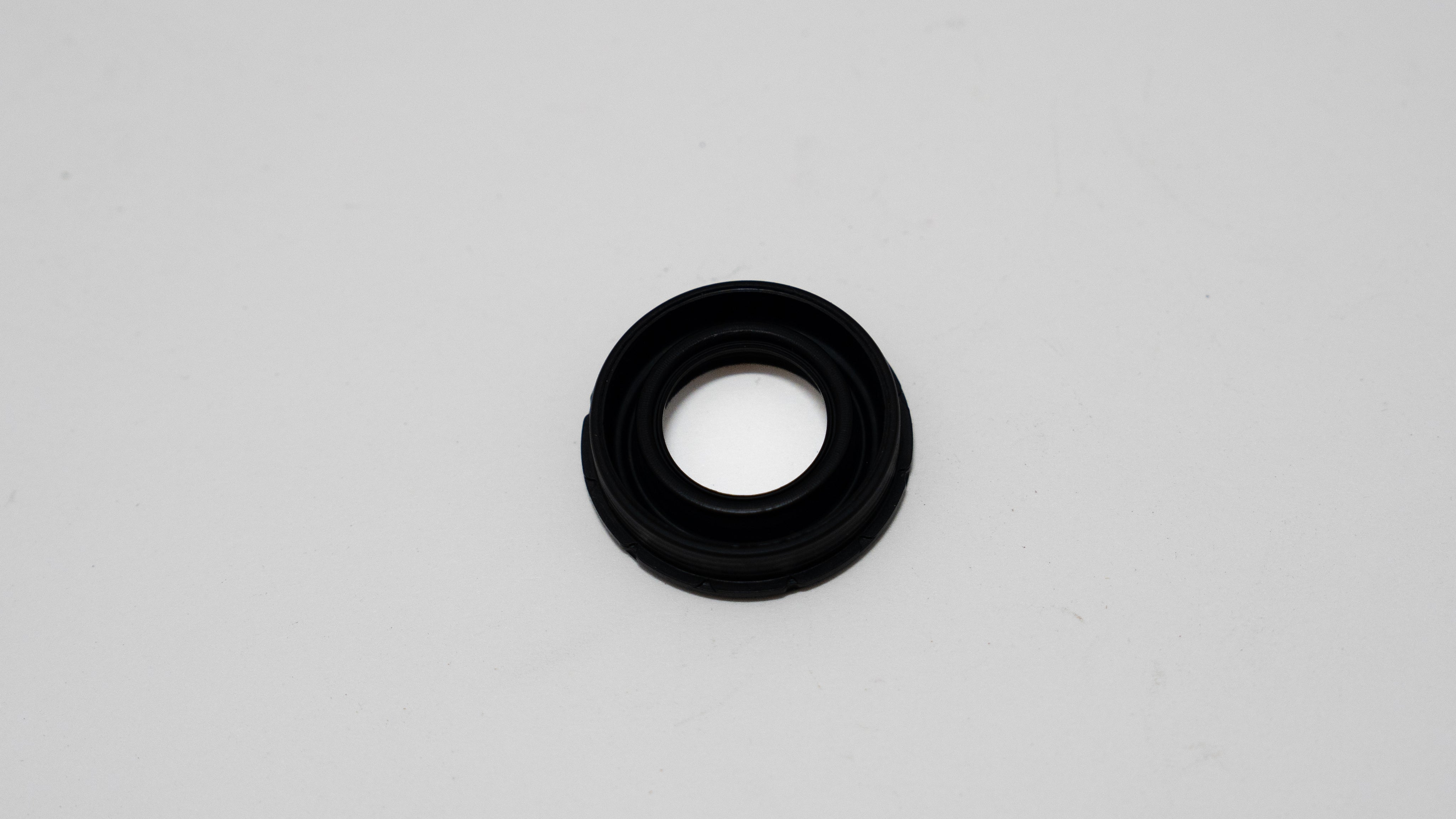 Black rubber automotive gasket on a gray background