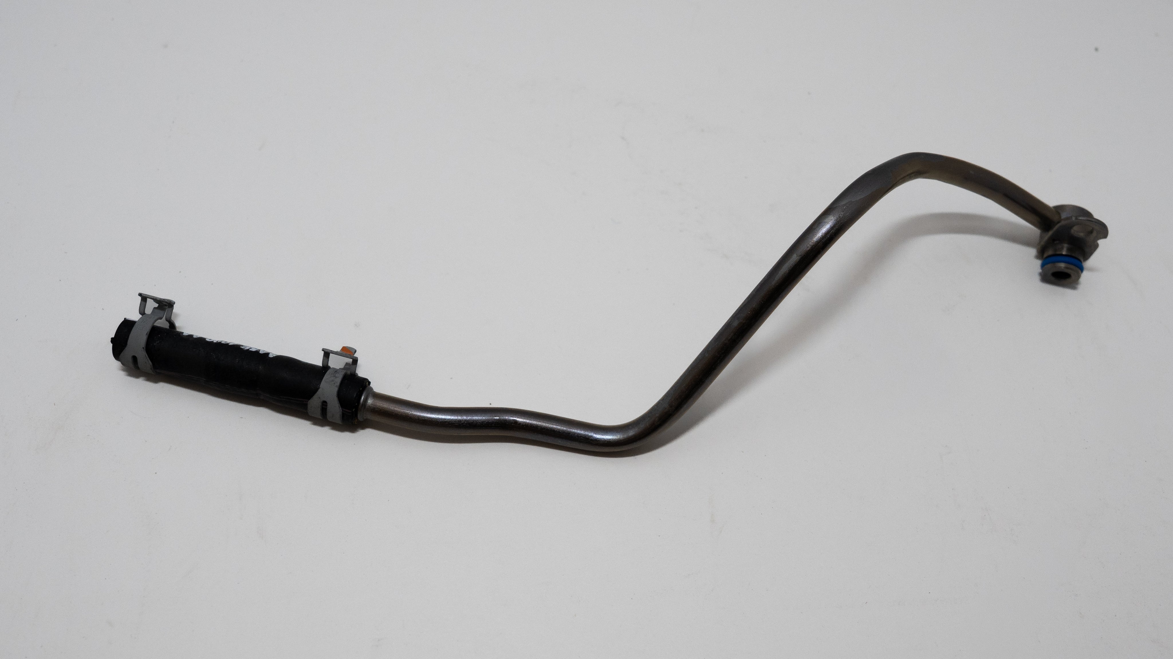 Black metal hose like water outlet truck part on a white background.