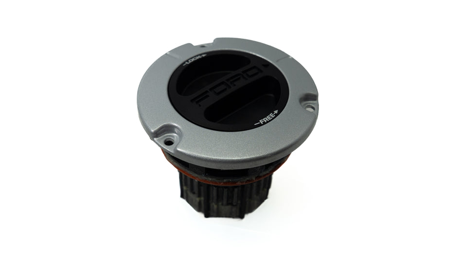 Circular metal wheel lock hub assembly on white background. 