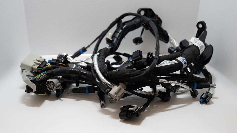 Complex arrangement of automotive wiring harnesses on a white background