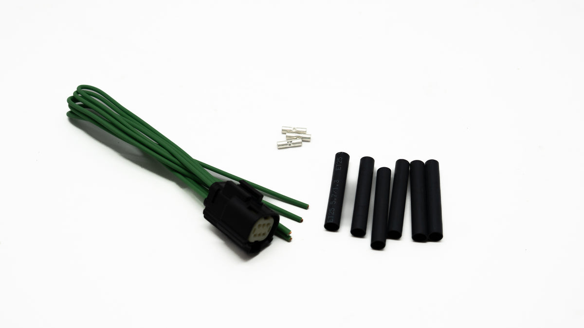 Green ignition cable set with connectors on a white background